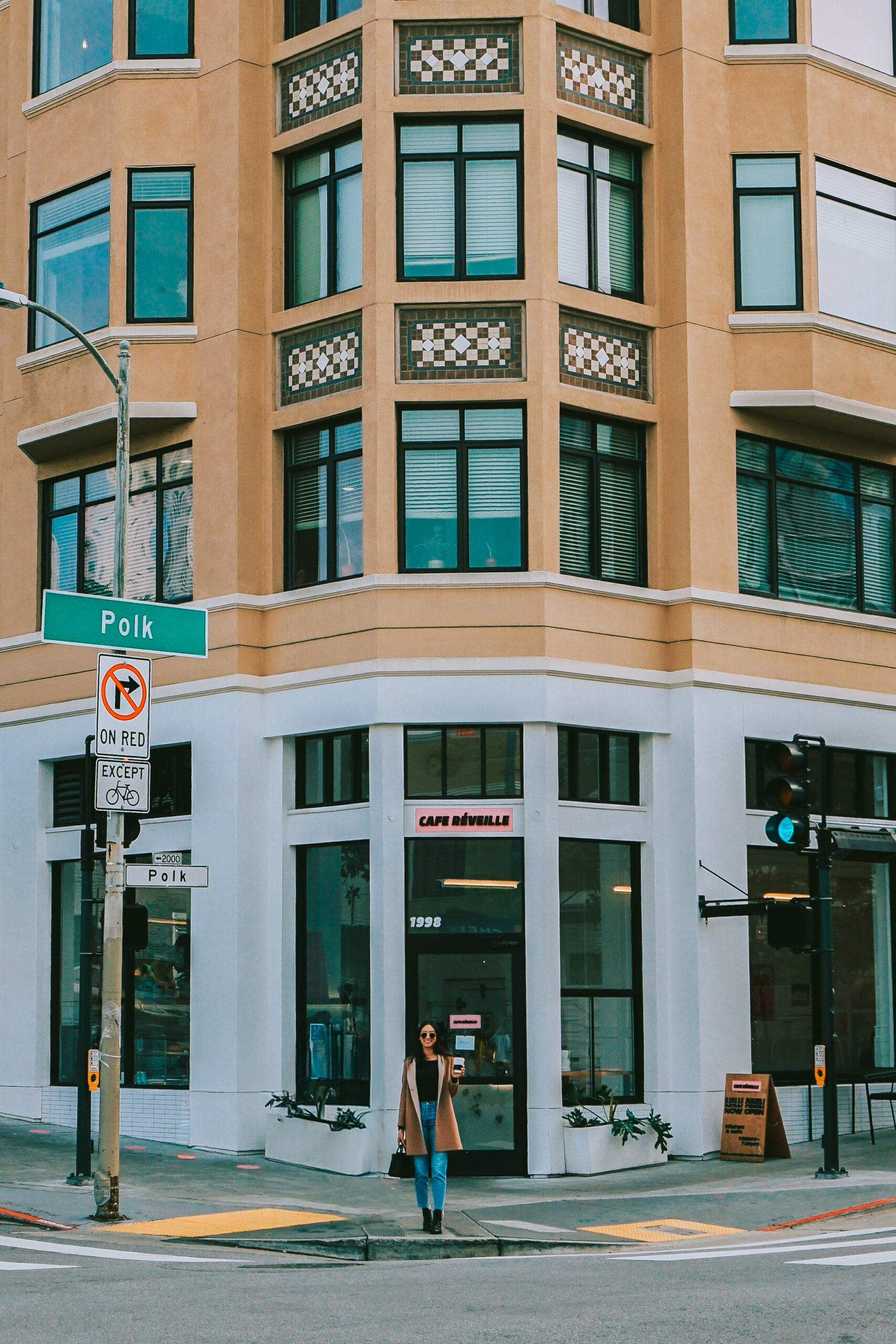 girl standing in front of reveille cafe on polk street, san francisco california