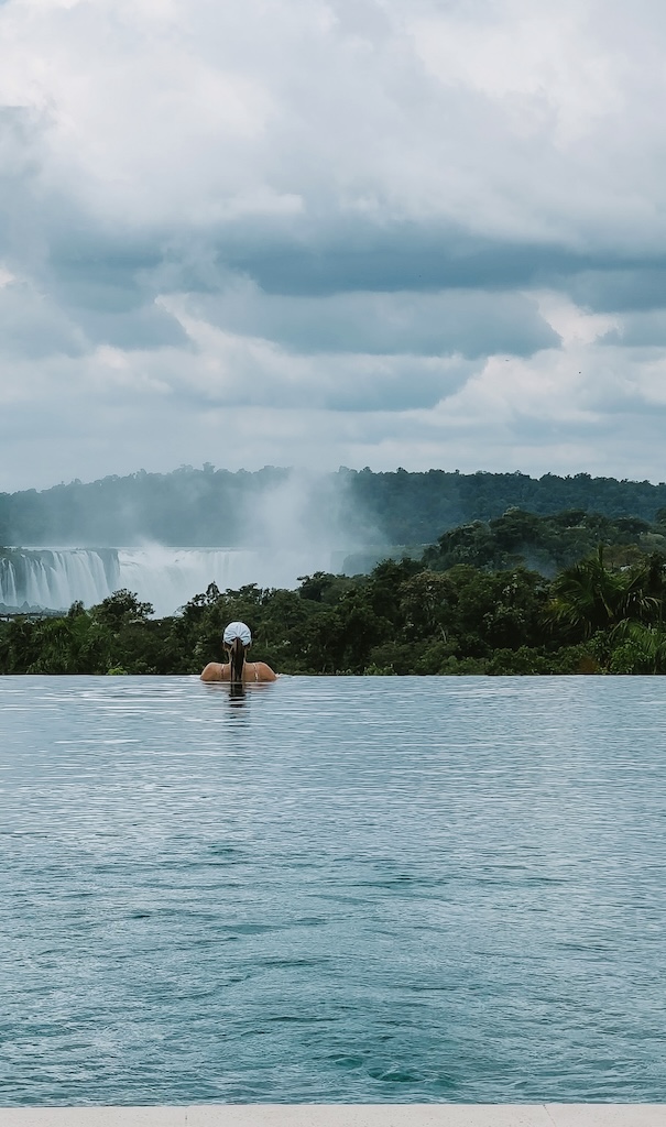 girl in pool overlooking iguazu falls at the gran melia iguazu falls hotel