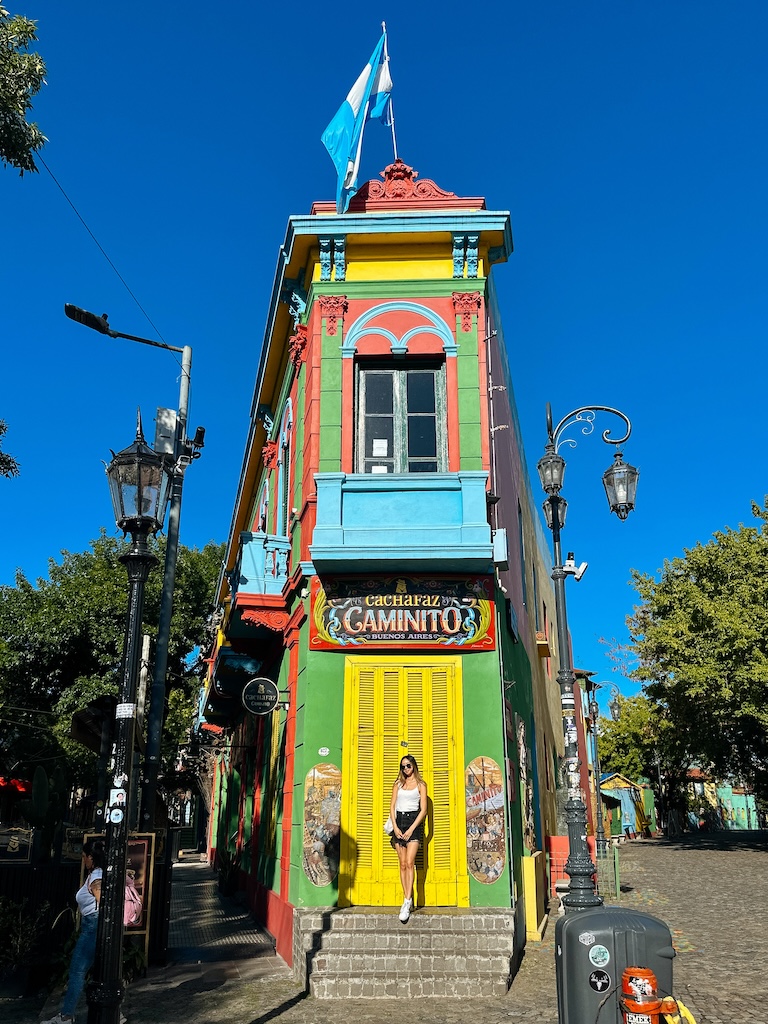 buenos aires 3 day itinerary, girl standing in front of caminito the famous landmark in la boca argentina