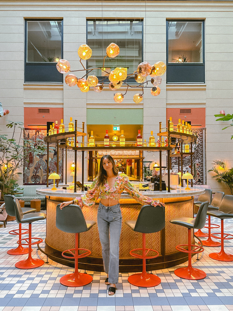 girl standing in front of the beautiful lobby bar at 25hours Hotel Indre By