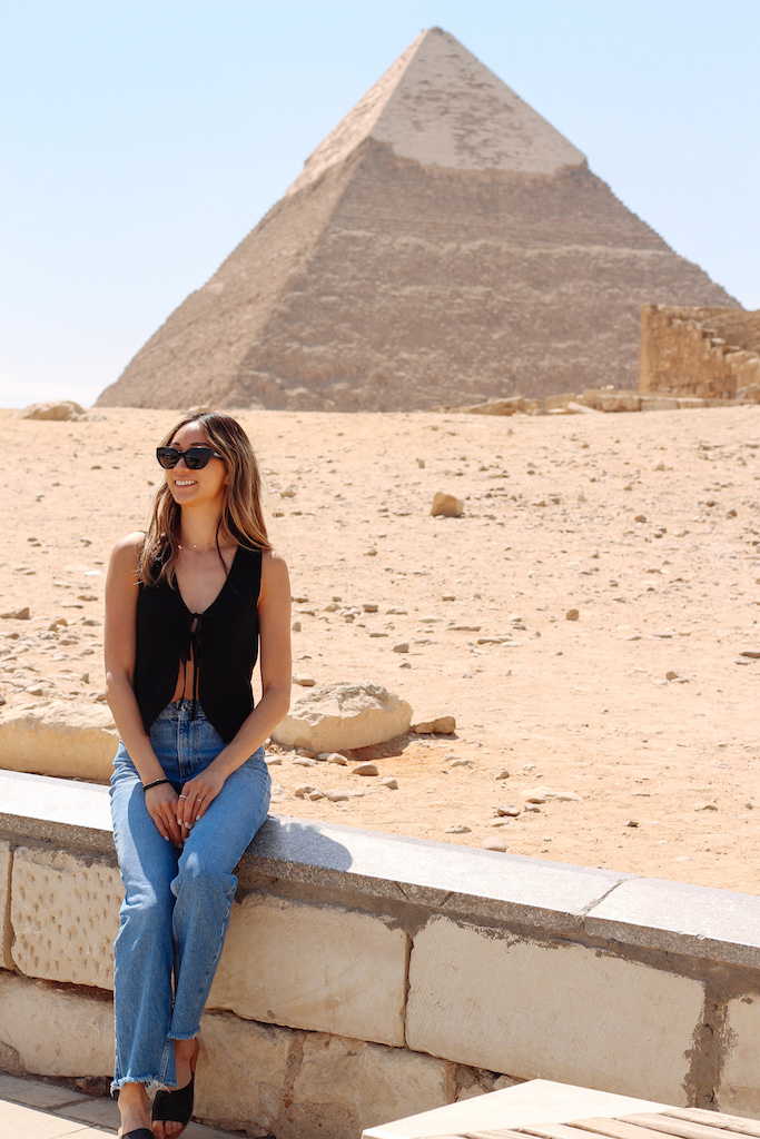 girl in front of pyramids of giza spending one day in cairo, for a stress-free 1 day cairo itinerary