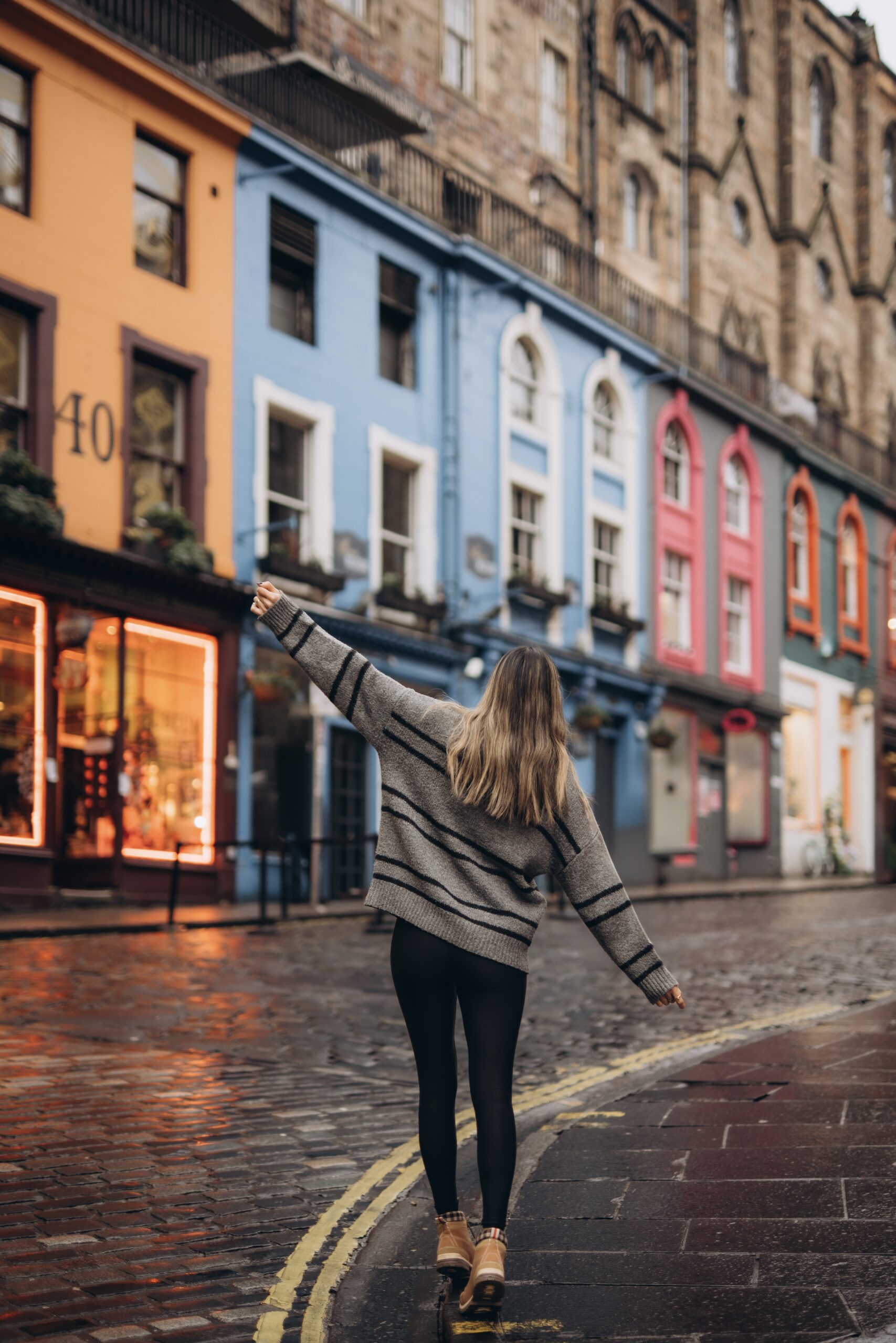 girl standing in front of victoria street in edinburgh, the best 3-day Edinburgh itinerary for first-time visitors